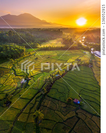 Beautiful morning view in Indonesia, panoramic landscape of rice fields with mountain ranges and clear sky Beautiful morning view in Indonesia, panoramic landscape of rice fields with mountain ranges and clear sky 136052915