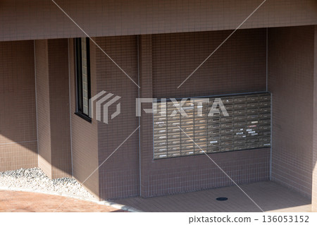 A mailbox installed on the exterior wall of an apartment building A mailbox installed on the exterior wall of an apartment building 136053152