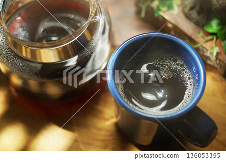 Coffee poured into mug Coffee poured into mug 136053395