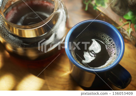 Coffee poured into mug 136053409