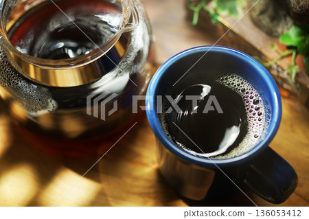 Coffee poured into mug Coffee poured into mug 136053412