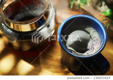Coffee poured into mug Coffee poured into mug 136053425