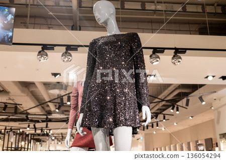 Sparkling sequin dress on mannequin in modern boutique 136054294
