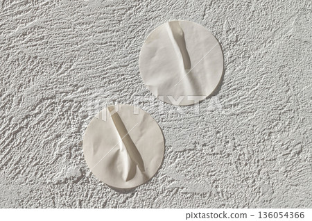 Minimalist aesthetic white round textured wall decor on plaster 136054366