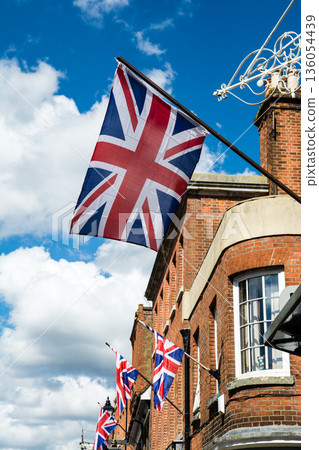 A historic brick building with lattice windows under bright sunlight in Windsor, a suburb of London A historic brick building with lattice windows under bright sunlight in Windsor, a suburb of London 136054439