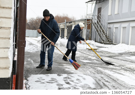 Winter cleaning and snow removal activity in a small town on a chilly morning 136054727