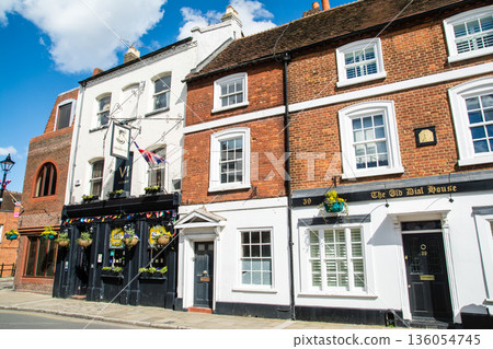 A historic brick building with lattice windows under bright sunlight in Windsor, a suburb of London A historic brick building with lattice windows under bright sunlight in Windsor, a suburb of London 136054745