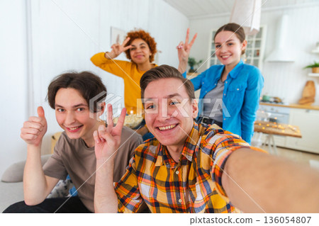 Cheers Funky mood. Happy friends make selfie. Man taking photo of friends at party. Group of multiracial people taking photo on phone. Young people enjoy their company smile have fun. Webcamera view Cheers Funky mood. Happy friends make selfie. Man taking photo of friends at party. Group of multiracial people taking photo on phone. Young people enjoy their company smile have fun. Webcamera view 136054807