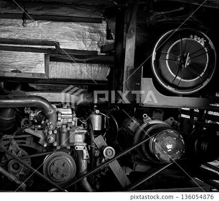 detailed view of a double decker bus engine bay showing belts, pulleys, radiator and hoses. Perfect for automotive maintenance, repair, and mechanical parts themes, conveys industry, repair work, and detailed view of a double decker bus engine bay showing belts, pulleys, radiator and hoses. Perfect for automotive maintenance, repair, and mechanical parts themes, conveys industry, repair work, and 136054876