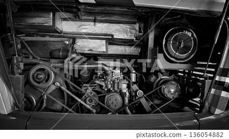 detailed view of a double decker bus engine bay showing belts, pulleys, radiator and hoses. Perfect for automotive maintenance, repair, and mechanical parts themes, conveys industry, repair work, and 136054882