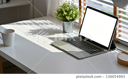 Modern desk work scene by a bright window (with copy space) 136054993
