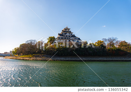 Okayama City: The Asahi River and Okayama Castle tower shining in the backlight Okayama City: The Asahi River and Okayama Castle tower shining in the backlight 136055342