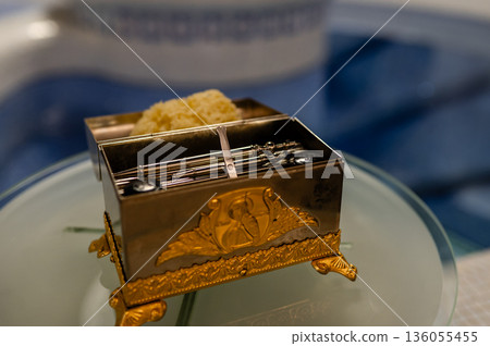 Priest's box with baptism accessories in an Orthodox church, prepared for the sacred ceremony and spiritual tradition 136055455