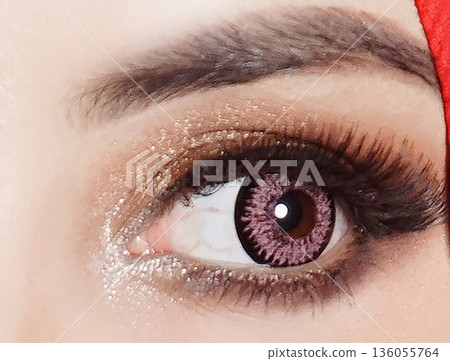 striking close up of a woman eyes accentuated by pink contact lenses, bold lashes, and shimmering makeup. Red framing the gaze, conveying fashion, confidence, and contemporary beauty striking close up of a woman eyes accentuated by pink contact lenses, bold lashes, and shimmering makeup. Red framing the gaze, conveying fashion, confidence, and contemporary beauty 136055764