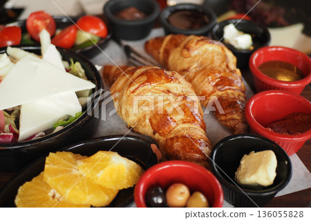 Breakfast with croissants and fresh fruits in a cafe 136055828