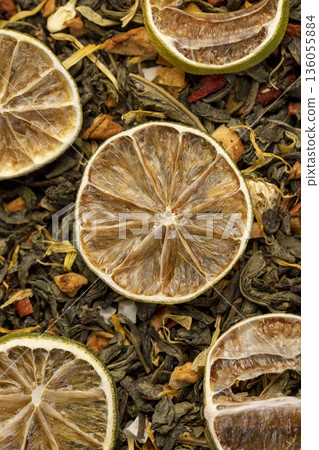 natural green tea with added pieces of fruit and cut dried green limes , bright large dry lime slices and green tea with pieces of fruit natural green tea with added pieces of fruit and cut dried green limes , bright large dry lime slices and green tea with pieces of fruit 136055884