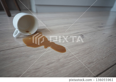 Spilled coffee on the wooden floor at home Spilled coffee on the wooden floor at home 136055961