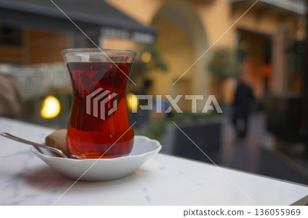 Warm Turkey tea served in a glass on a table in a cafe Warm Turkey tea served in a glass on a table in a cafe 136055969
