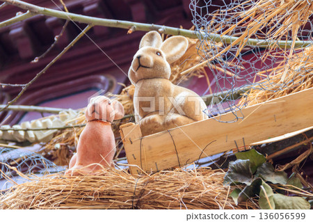 Easter decoration with Easter bunnies on a house Easter decoration with Easter bunnies on a house 136056599