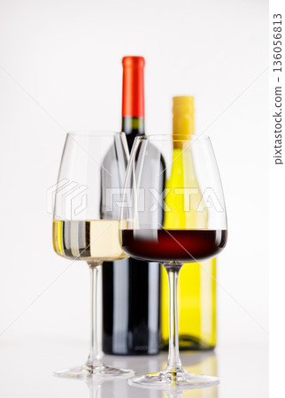 Different wine bottles and glasses on white background 136056813