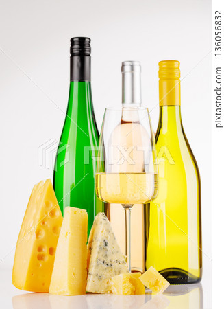 Assorted cheeses and wine on white background Assorted cheeses and wine on white background 136056832