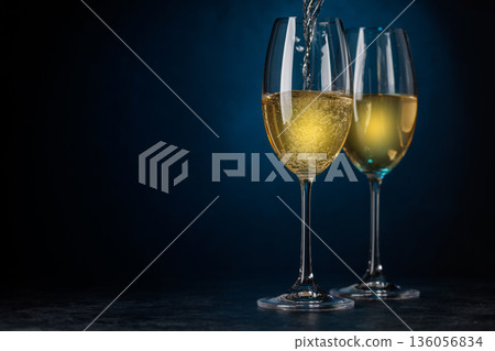 Champagne glasses on dark blue background Champagne glasses on dark blue background 136056834
