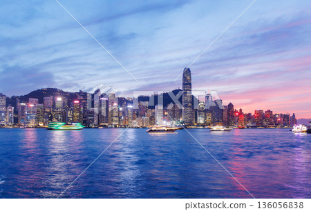 Hong Kong city skyline at sunset with glowing sky and skyscrapers Hong Kong city skyline at sunset with glowing sky and skyscrapers 136056838