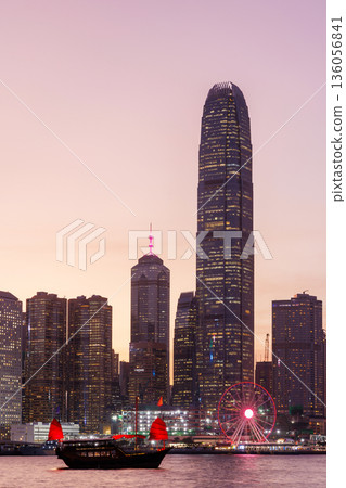 Hong Kong city skyline at sunset with glowing sky and skyscrapers Hong Kong city skyline at sunset with glowing sky and skyscrapers 136056841