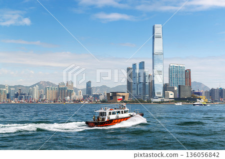 Hong Kong skyscraper panorama on a sunny day with water and boats 136056842