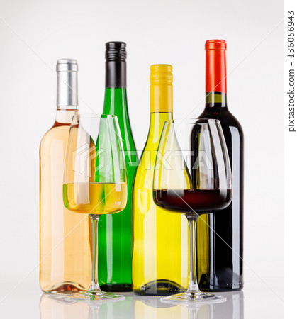Different wine bottles and glasses on white background 136056943