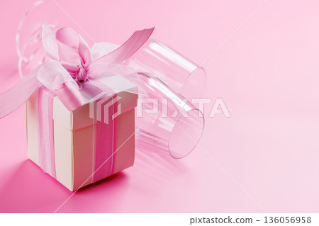 Gift box and wine glasses on pink background Gift box and wine glasses on pink background 136056958