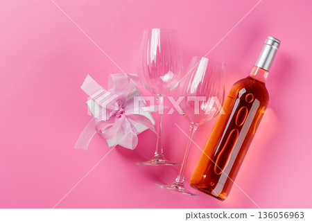 Gift box and wine glasses on pink background Gift box and wine glasses on pink background 136056963