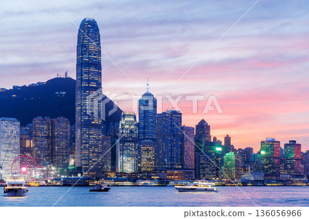 Hong Kong city skyline at sunset with glowing sky and skyscrapers Hong Kong city skyline at sunset with glowing sky and skyscrapers 136056966