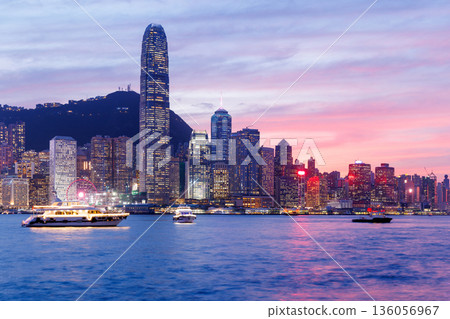 Hong Kong city skyline at sunset with glowing sky and skyscrapers Hong Kong city skyline at sunset with glowing sky and skyscrapers 136056967