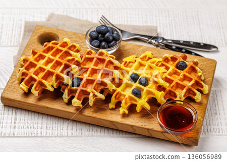 Homemade waffles with maple syrup 136056989