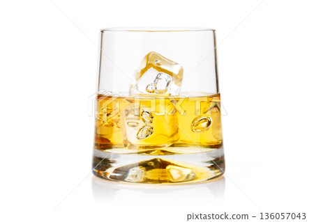 Whiskey glass with ice on white background Whiskey glass with ice on white background 136057043
