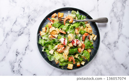 Caesar salad, with shrimp, on a marble background, top view, no people, 136057074