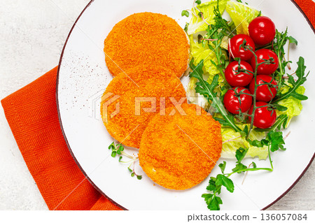 crispy fried fish cutlets, fish burgers, on a white plate, with fresh lettuce leaves, arugula and cherry tomatoes, homemade, no people, crispy fried fish cutlets, fish burgers, on a white plate, with fresh lettuce leaves, arugula and cherry tomatoes, homemade, no people, 136057084