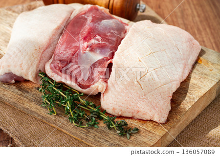 Fresh raw duck breast, on a wooden chopping board, top view, no people, Fresh raw duck breast, on a wooden chopping board, top view, no people, 136057089