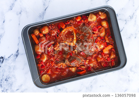 ossobuco stew with vegetables, knuckle on the bone with new potatoes, in tomato sauce,homemade, top view, no people, 136057098