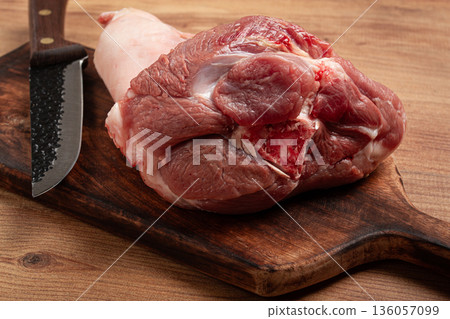 Raw pork knuckle, on a wooden chopping board, close-up, top view, no people, Raw pork knuckle, on a wooden chopping board, close-up, top view, no people, 136057099