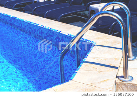 stainless steel staircase, in the pool, bright sunlight, no people, 136057100