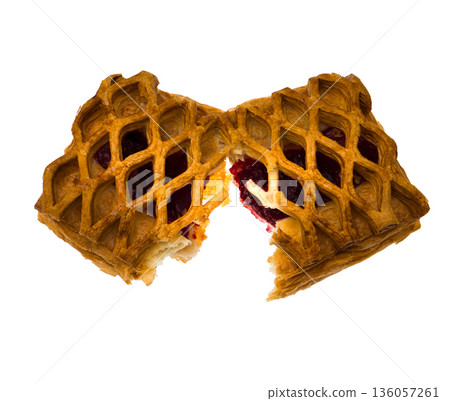 Baking, puff pastry bun mesh with cherry filling broken in half on white background isolated Baking, puff pastry bun mesh with cherry filling broken in half on white background isolated 136057261