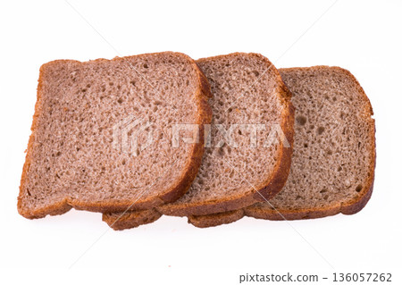sliced slices of dark bread from a mixture of wheat and rye flour on a white background sliced slices of dark bread from a mixture of wheat and rye flour on a white background 136057262