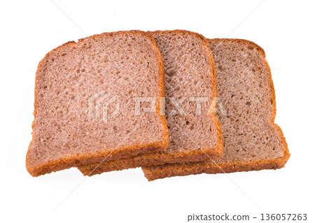 sliced slices of dark bread from a mixture of wheat and rye flour on a white background sliced slices of dark bread from a mixture of wheat and rye flour on a white background 136057263