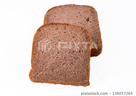 sliced slices of dark bread from a mixture of wheat and rye flour on a white background sliced slices of dark bread from a mixture of wheat and rye flour on a white background 136057265