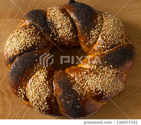 Sweet Slavic bun made in the shape of a ring and called Kalach 136057342