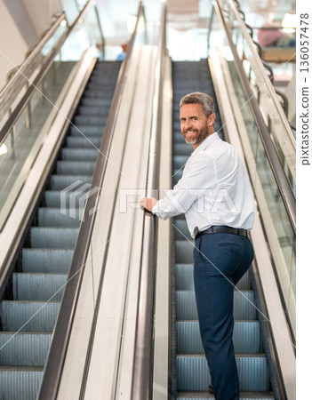 Airport and business travel. International business trip. Metro train station. Airport terminal escalator. Businessman escalator in subway station. Elegant man in business center. Man shopping mall Airport and business travel. International business trip. Metro train station. Airport terminal escalator. Businessman escalator in subway station. Elegant man in business center. Man shopping mall 136057478