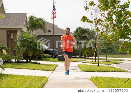 smiling sport runner run outdoor. sport runner having run workout. photo of sport runner run. 136057593