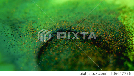 Glitter fluid defocused. Paint blob. Yellow green shiny particles blend abstract background. Bright pigment mix color on black circle blotch. 136057756